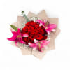 Wrapped bouquet of red roses with pink lilies and white baby's breath