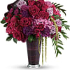Bouquet of pink and purple roses in a tall vase