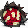 Bouquet of red and white roses wrapped in black paper
