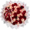 Bouquet of red and cream roses with a burgundy ribbon and spider decorations