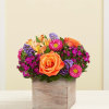 Orange roses and mixed purple-pink flowers in a wooden box