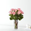 Pink roses arranged in a clear glass vase