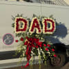 Floral standing arrangement spelling "DAD" with red and white roses