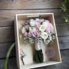 Pink and white rose bouquet in a wooden box