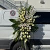 Large white floral standing spray with roses and orchids