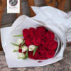 Bouquet of red roses and white tulips wrapped in white paper