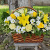 Basket arrangement of yellow lilies, roses, and white daisies