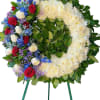 Heart-shaped floral wreath with red, white, blue, and purple flowers
