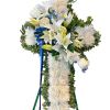White floral standing cross with blue ribbon accents