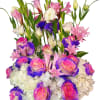 Tall bouquet of pink and white flowers with purple-tipped roses