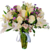 White lilies and roses with purple daisies in a glass vase