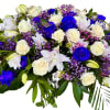 Bouquet of white and vivid blue roses with purple filler flowers