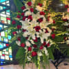 Large standing floral spray with red roses and white lilies