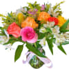 Mixed bouquet of roses and alstroemeria in a glass vase