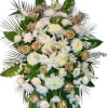 Large white and gold funeral spray with roses and lilies