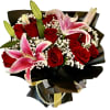 Bouquet of red roses and pink lilies wrapped in black paper