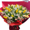 Bouquet of yellow and white tulips with baby's breath in red wrapping