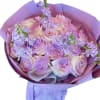 Lavender and blush rose bouquet wrapped in purple paper
