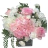 Pink roses and white hydrangeas in a square glass vase