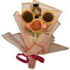 Crocheted sunflower bouquet with a small doll figure and pink wrapping