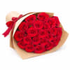 Bouquet of red roses wrapped in brown paper with a red ribbon