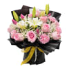 Soft pink roses and carnations mingle with creamy white lilies in this