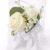Ivory-white roses gathered into a wearable wrist corsage create a quietly elegant