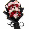 Deep red and soft pink roses mingle with clouds of white baby's