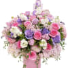 Large bouquet of pink and purple roses in a pink hatbox