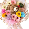 Bouquet with a teddy bear surrounded by colorful gerbera daisies and carnations
