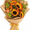 Bouquet of sunflowers wrapped in brown paper with a yellow ribbon