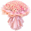 Large bouquet of pink roses wrapped in layered pink paper with ribbon