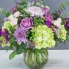Bouquet of purple and white flowers in a glass vase