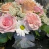 Bouquet of pink and peach roses with white daisies and carnations