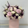 Pink and white floral arrangement in a blush cylindrical box