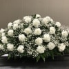 A timeless tribute of love and remembrance, this elegant casket spray features
