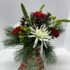 Clear vase with mixed greens, fresh flowers &amp; plaid box.
