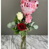 Roses in a glass vase with a pink heart balloon
