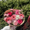 Pink mixed flower bouquet with roses and gerbera daisies wrapped in paper