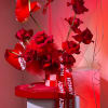 Red roses with heart-shaped anthuriums and a honey ribbon in a gift box