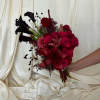 Bouquet of deep red flowers with black calla lilies