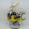 Yellow and blue flowers in a patriotic ceramic pot wrapped in plastic