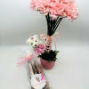 Pink carnation arrangement in a pot with a teddy bear and wrapped pretzels