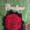 Large bouquet of red roses wrapped in black paper