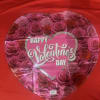 Heart-shaped Valentine’s Day balloon with pink roses and red background