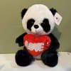 Plush panda holding a red heart with the word LOVE
