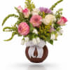 Bouquet of pink and white flowers in a brown vase with a white ribbon