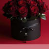 Bouquet of deep red roses in a black round box