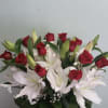 Bouquet of red roses and white lilies with a red ribbon