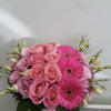 Pink roses and gerbera daisies in a round box arrangement